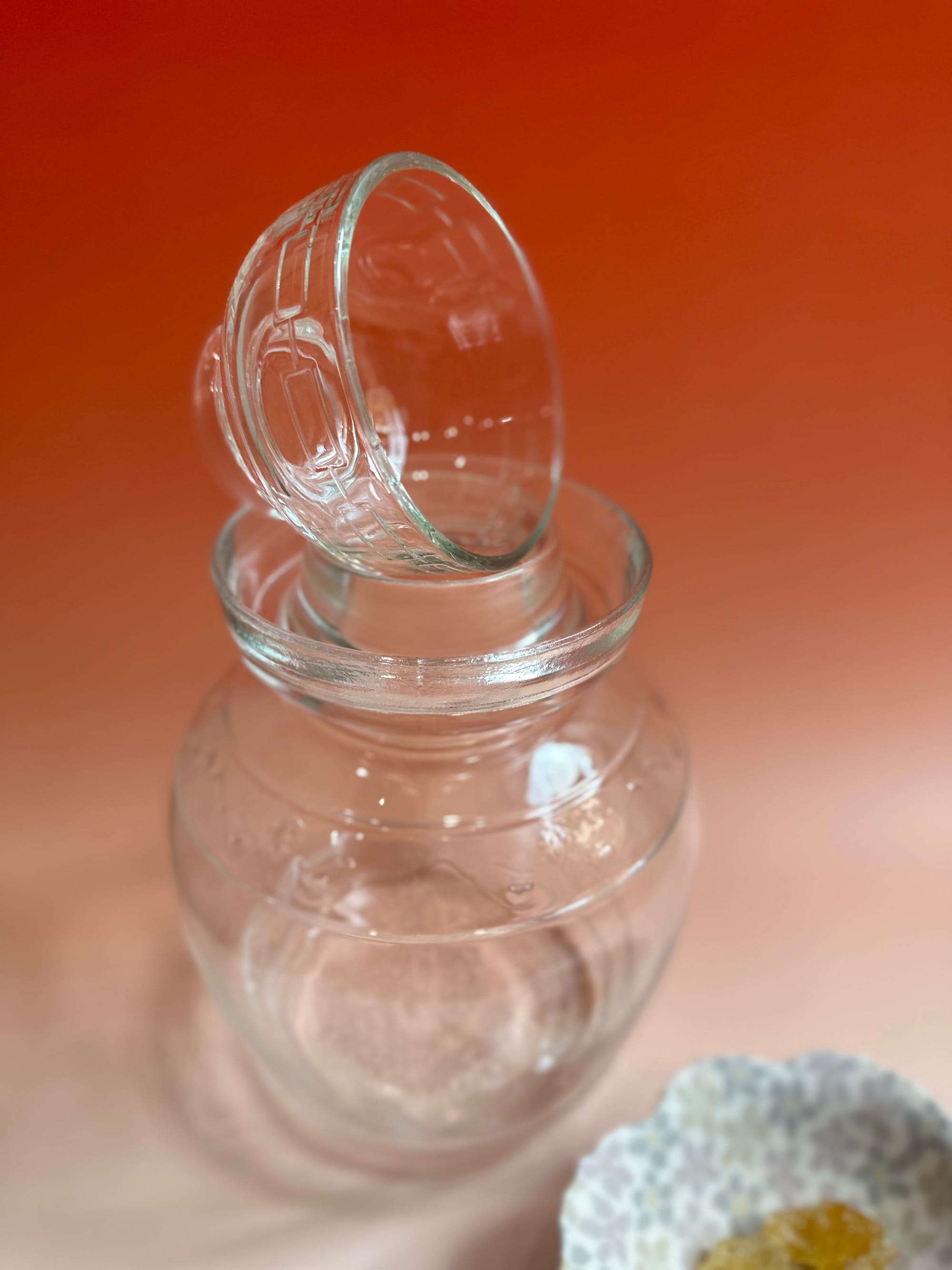 A glass pickling jar with it's lid resting on top.