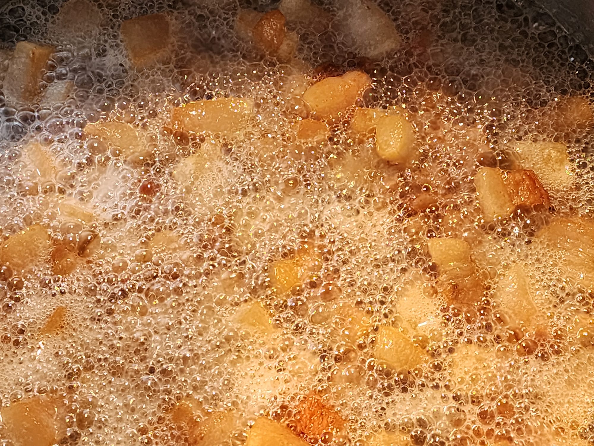 Rendered chunks of golden pork covered in bubbles.