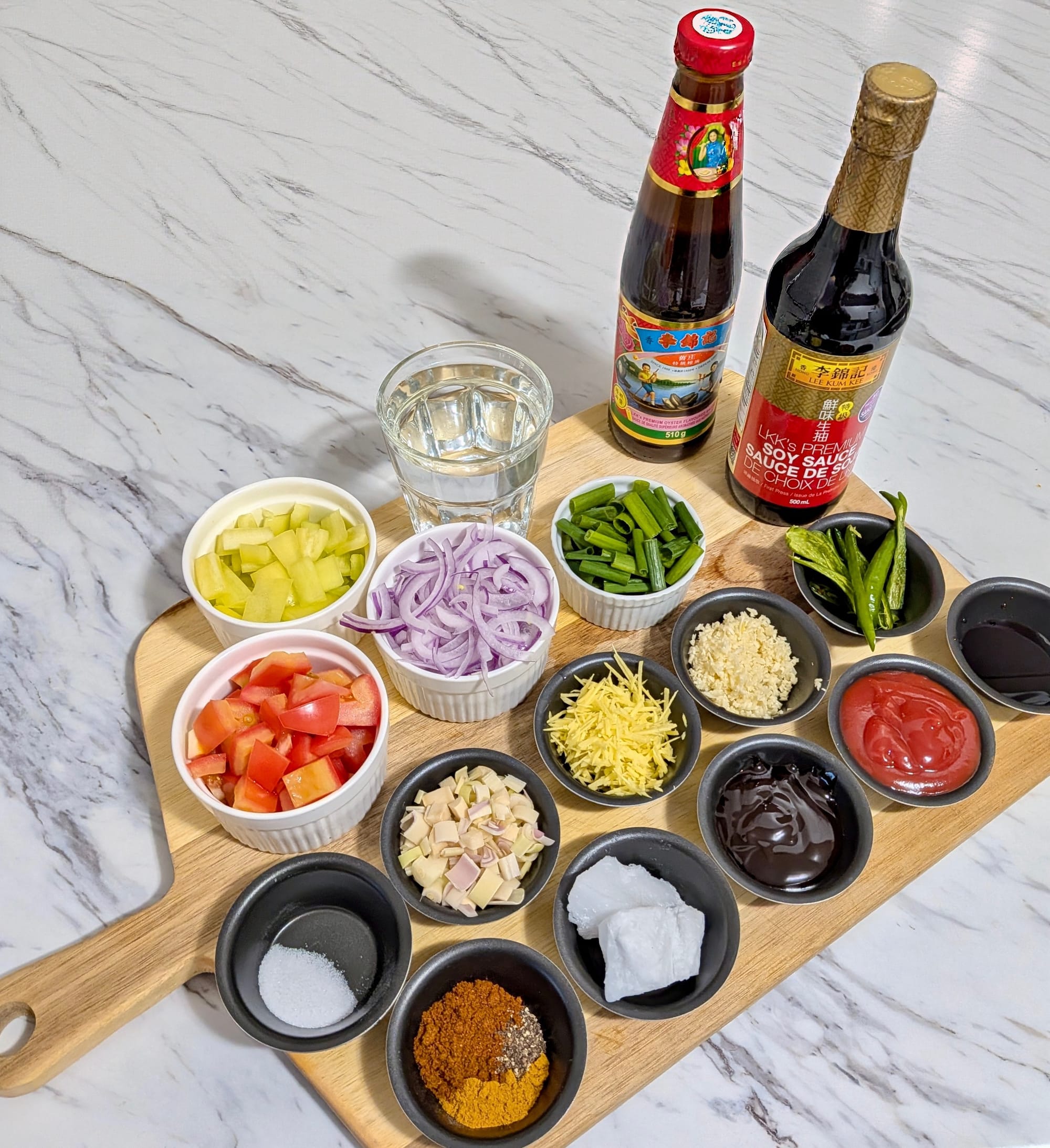 Portioned trays of spices and raw vegetable ingredients and sauces for Deviled Crab.