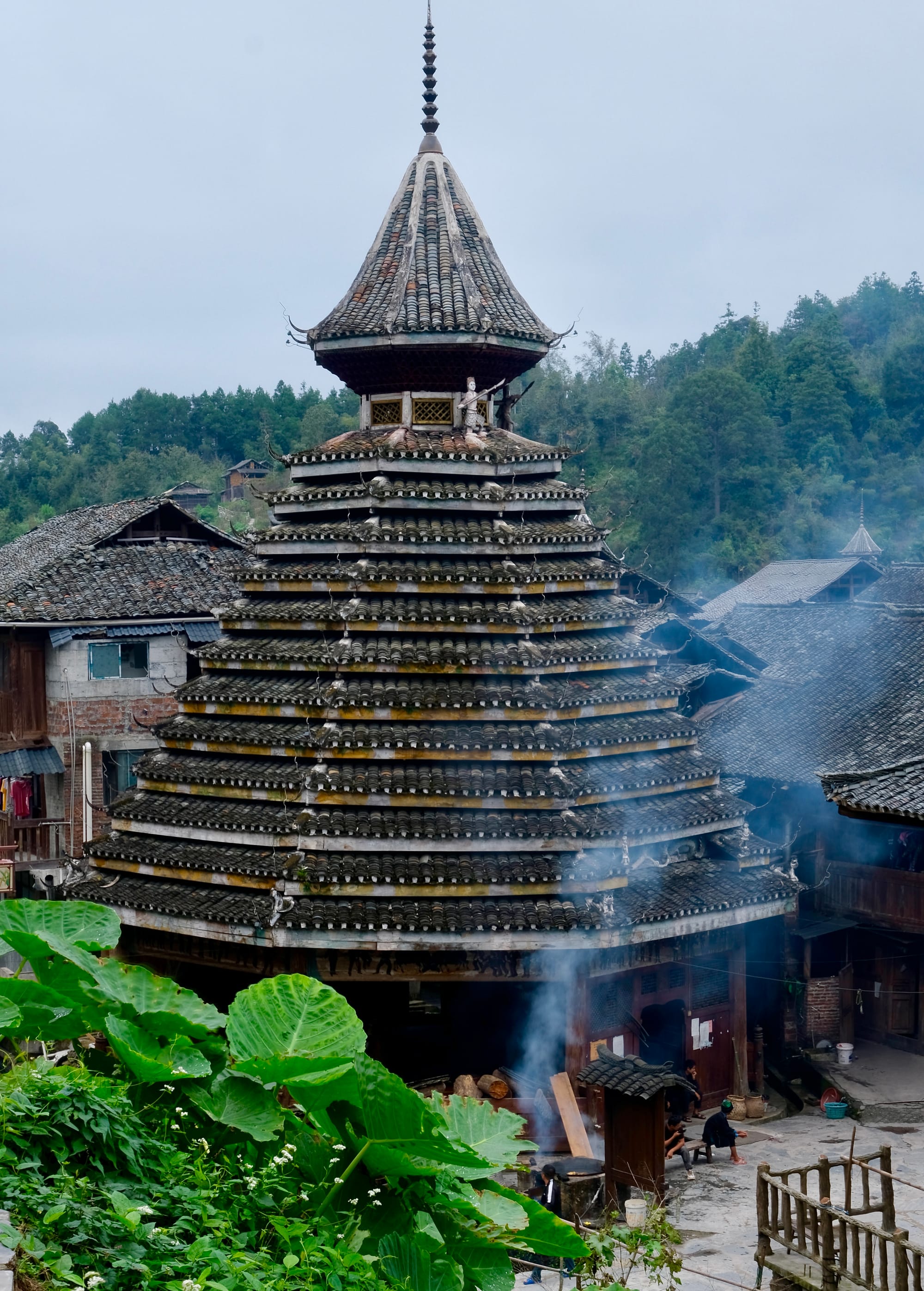 A Dong drum tower in the center of the village - a tiered cone shape topped with a small spire. 