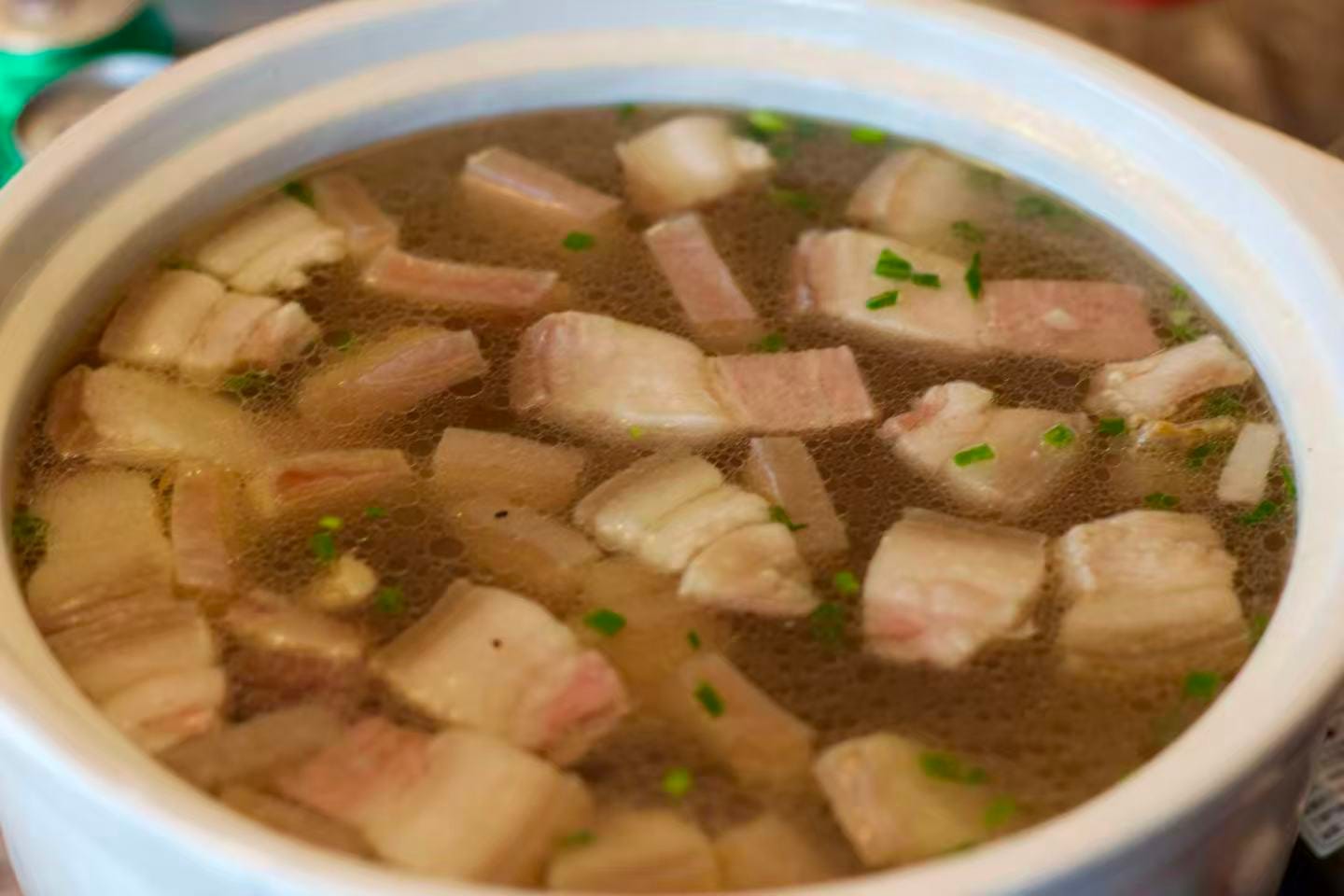 Ham soup - a golden broth with chunks of ham floating around the top.
