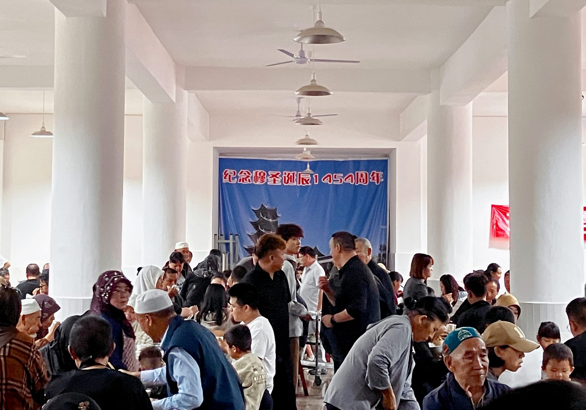 Guests gather in the great hall of a local mosque for a traditional Hui Muslim wedding. 